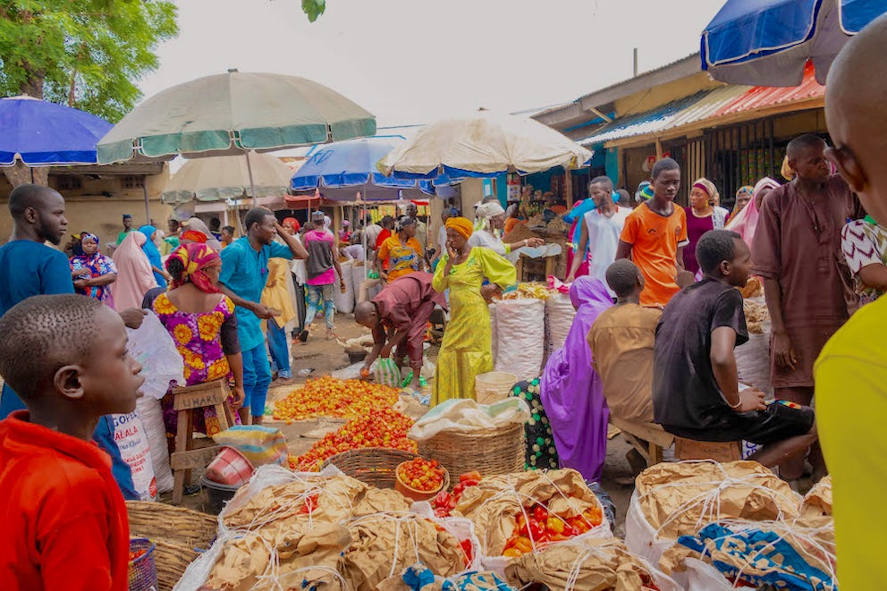 People mill around a busy market in Nigeria